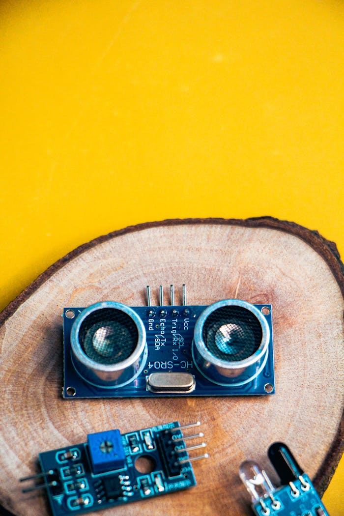 The Art of Drawing Readers In: Your attractive post title goes here Close-up of electronic modules on a wooden slice against a vibrant yellow background.