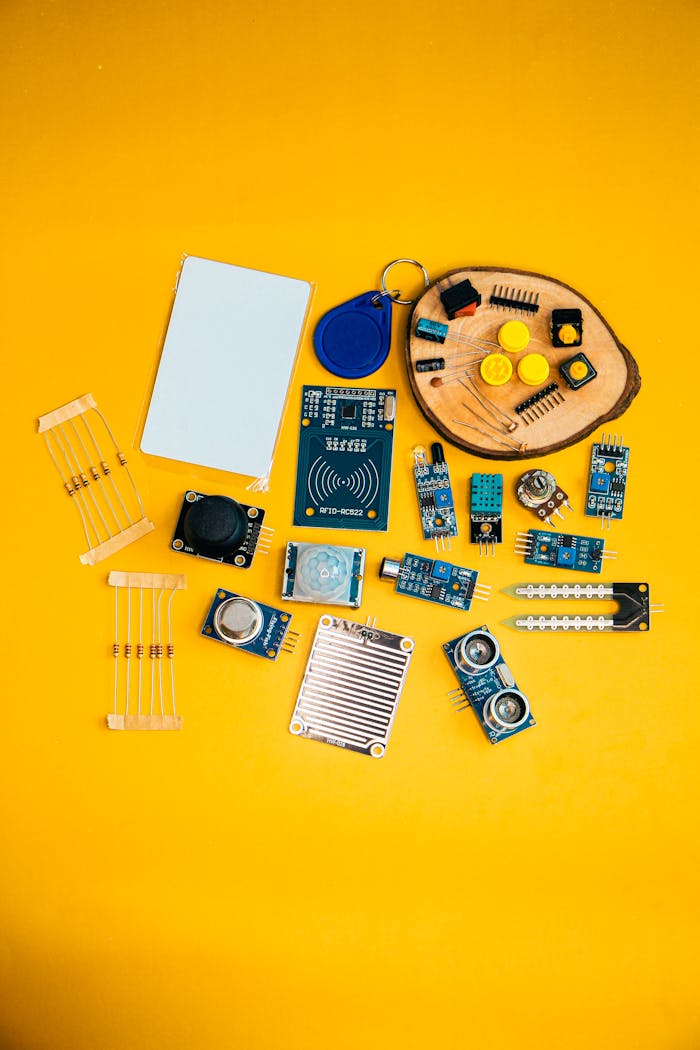 Crafting Captivating Headlines: Your awesome post title goes here A collection of electronic components arranged on a vibrant yellow background, showcasing technology innovation.